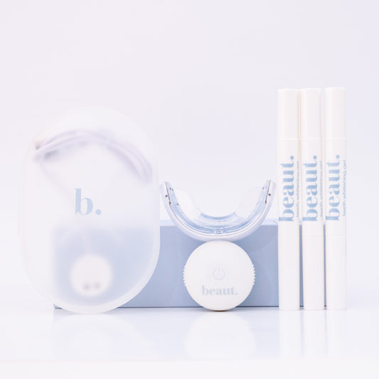 Clear dental device with white ball and packaging on a light blue background