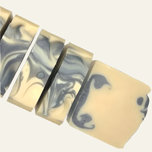 Marbled soap bars with black and gray swirls on a white background