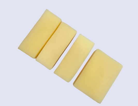 four rectangular yellow soaps on a white background