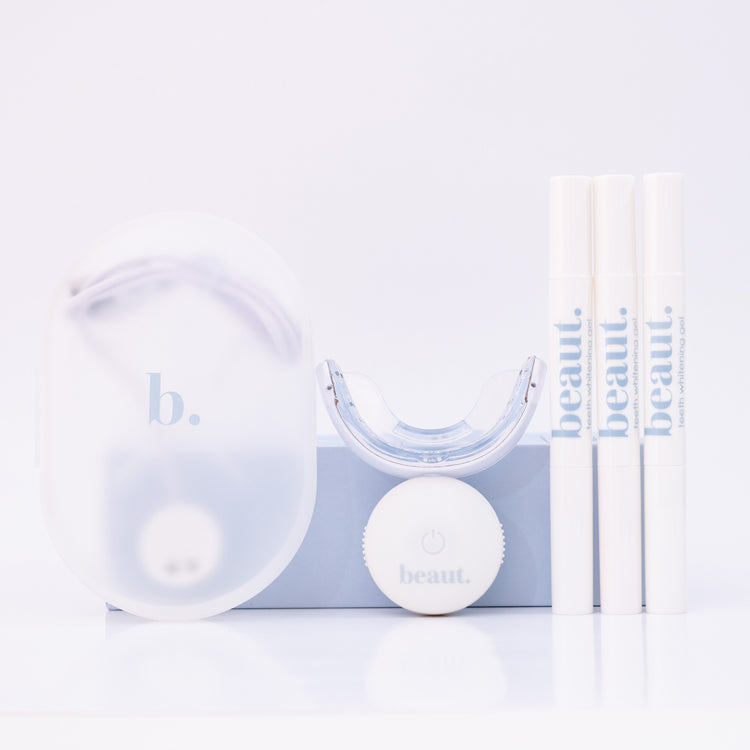 Clear dental device with white ball and packaging on a light blue background
