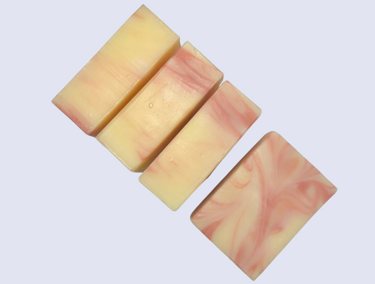 Set of five soap bars with a pink and beige marbled pattern on a white background