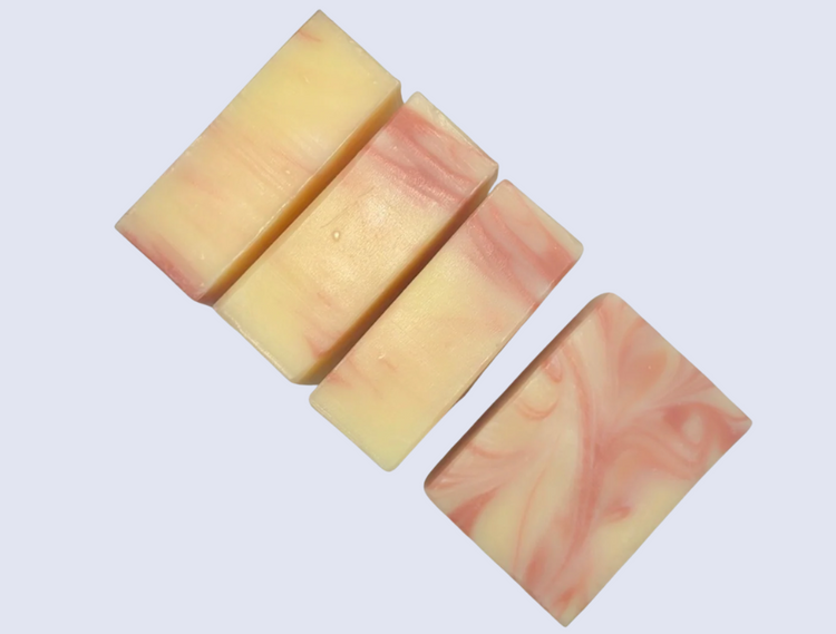 Set of five soap bars with a pink and beige marbled pattern on a white background