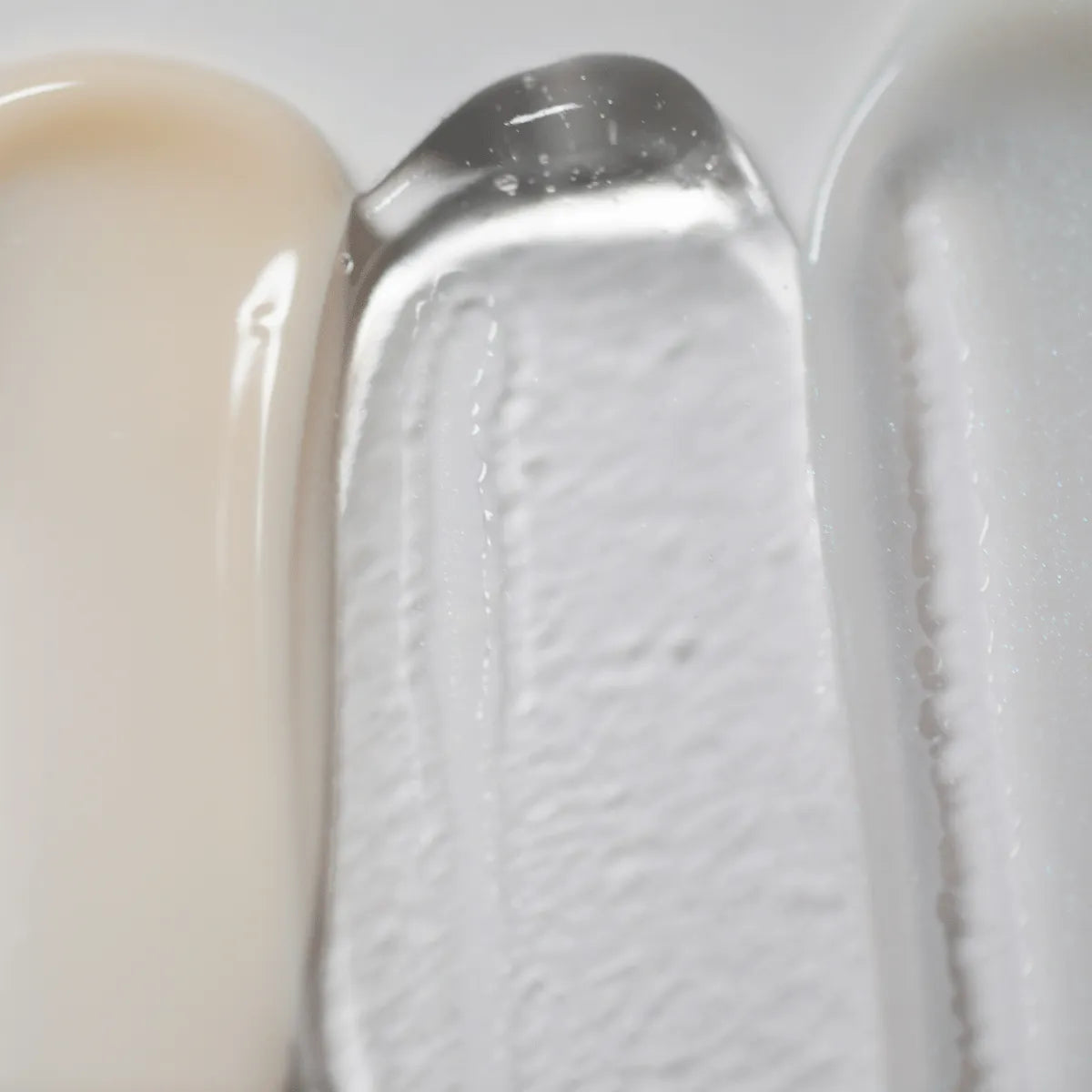 Close-up of three anti aging serums on a white background