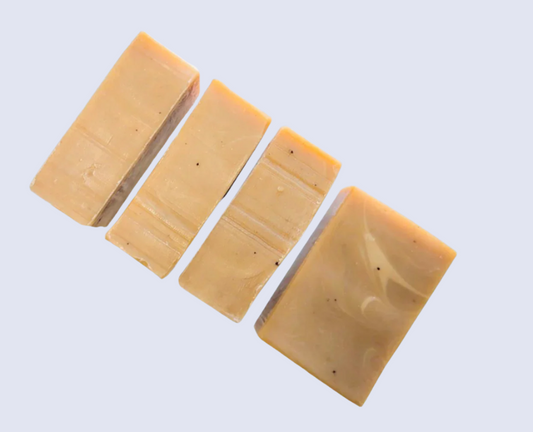 Four rectangular soap bars with a marbled pattern on a white background