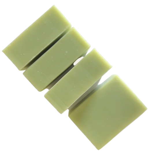Four light olive green soap bars stacked on a light cream background